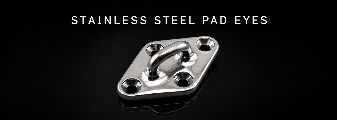 Four-hole stainless steel pad eye on a black reflective background