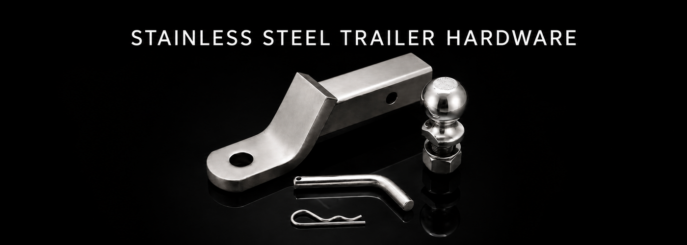 Stainless steel trailer coupler, hitch ball, winch and tie-down hardware on a black reflective background