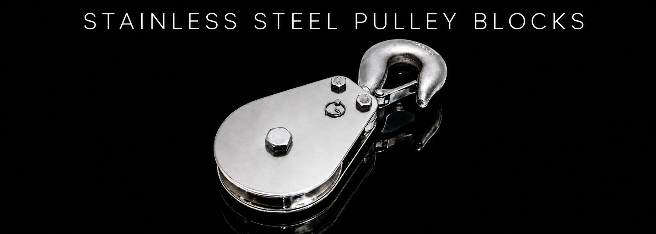 Stainless steel pulley block with hook on a black reflective background